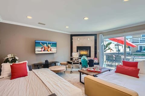 Open and beautiful living room design with two sofa that open to full size beds, 50” 4K TV, fireplace, games, beautiful decor, and so much more!