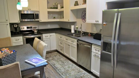 Stove, oven, coffee maker, microwave, dishwasher and fridge. 