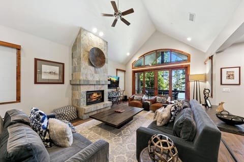 Cozy living room with gas fireplace, lake views, and 55-inch Smart TV with streaming
