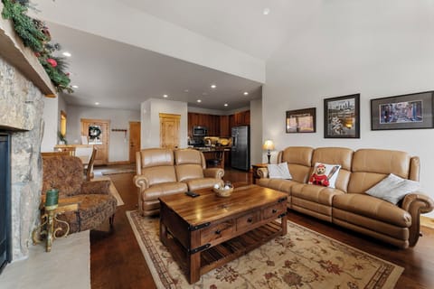 The living area features a flat-screen TV, a gas fireplace, and access to the private balcony.