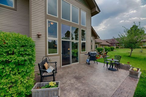 Outdoor Patio with Glider Bench, Table, and Grill