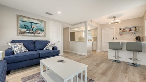 Spacious living room with seating for 5, flat panel HDTV off of the kitchen and dining room