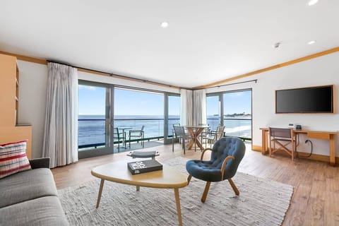 Expansive glass doors and windows providing clear views of the ocean