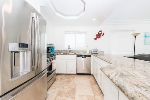 The kitchen comes stocked with dishes, utensils, cookware, bakeware, and large & small appliances.
                