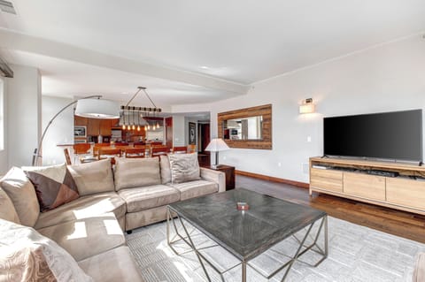 Lowell 402 living room with large sectional sofa and flat screen TV.