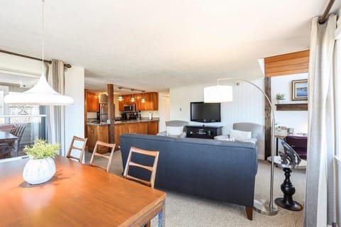 Dining room overlooking living room, desk area and kitchen with window onto deck