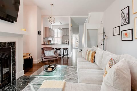 Open-concept living room with plush seating, fireplace, and seamless flow into the kitchen. #StayTogether