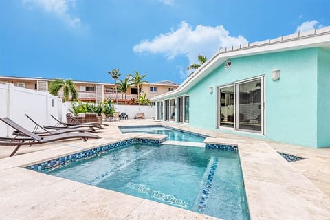 Outdoor oasis with heated pool, hot tub, BBQ and ample seating to relax