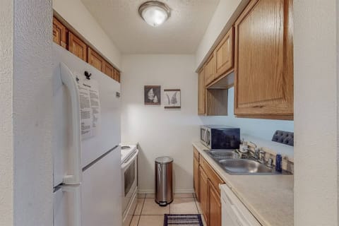 Refrigerator, microwave, electric stove, dishwasher int he full kitchen