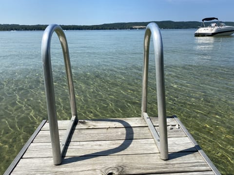 Beautiful view from the dock of the crystal clear lake with sandy bottom.  