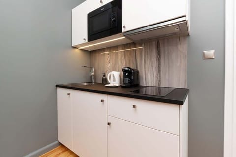 The fully equipped kitchenette includes everything you need for a home-cooked meal.