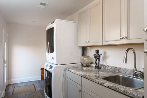 Stacked Washer and dryer - rear entrance on South East corner