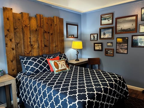 Full size bed in the Bedroom. Photos taken by local artists. 