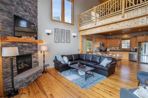 Great Room with Huge Stone Gas Log Fireplace and HD Smart TV, Custom Log and Branch Balustrade on Loft Above