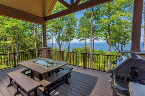 Enjoy glorious views from the massive covered deck while socializing at the fire table and making meals on the gas grill