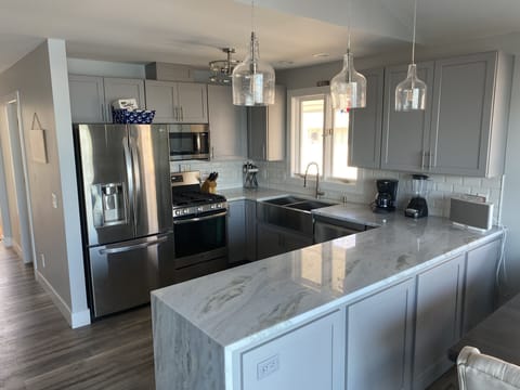 Kitchen includes a waterfall granite countertop