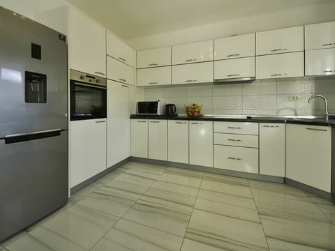 Cabinetry, Countertop, Kitchen Stove, Kitchen Appliance, Kitchen, Drawer, Building, Sink, Flooring, Interior Design