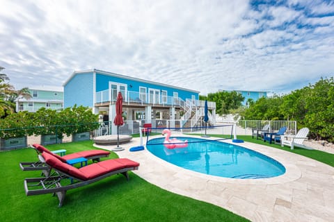 Back yard with concrete pool that has a heater and LED lights.
