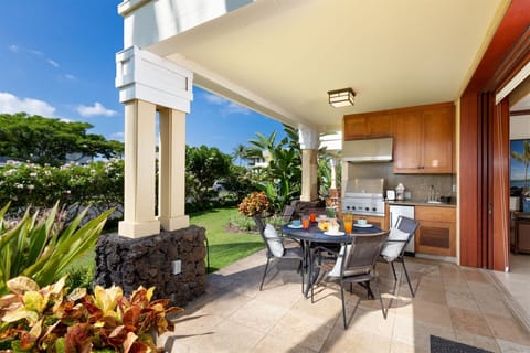Covered lanai dining space and outdoor kitchen with built in grill