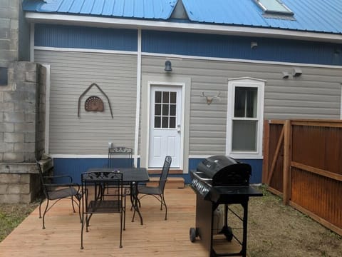 Fence patio area with gas grill