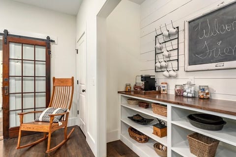 Coffee bar is complete with Keurig, coffee, tea, sugar, cream, microwave, and more.