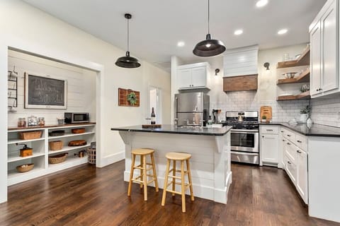 The cottage's gorgeous, fully remodeled kitchen is perfect for feeding the whole crew. Features island, stainless appliances, coffee bar, and open shelving.