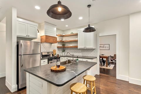 Our kitchen was made for entertaining! A gorgeous kitchen island, subway tiled back splash, farmhouse lighting details, and all new appliances make this kitchen a 10/10. Walk through the kitchen straight into the dining area!