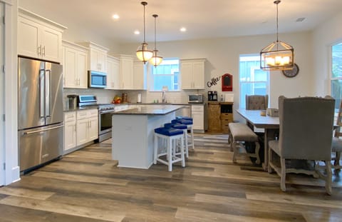 Large chef kitchen with seating for 13 and 3 more at high top table.