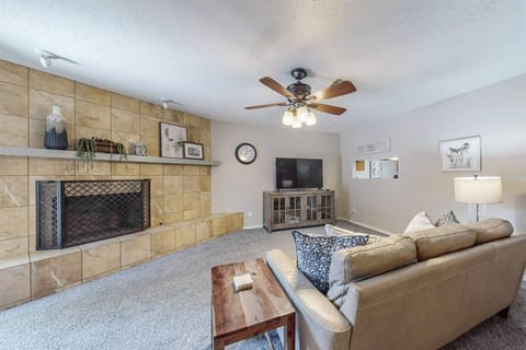 The living room offers a sliding glass door with a small backyard space shared with the neighboring unit.