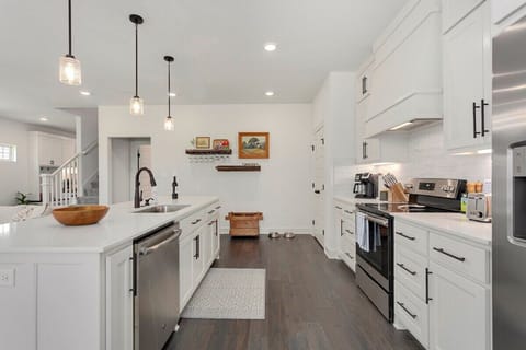 Our home's kitchen is perfect for staying in or entertaining! Some of our favorite details include: 2 floating wine shelves, gorgeous white cabinetry, all new appliances, a dual choice coffee maker (Keurig or pot), & 4-burner stove top.