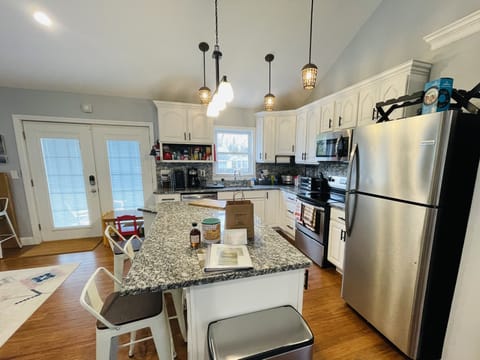 Stainless steel appliances and granite counter with seating for 3. Spring 2022