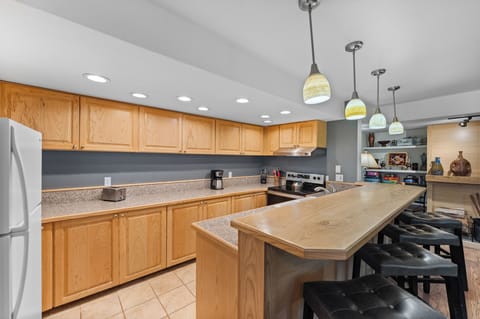 The kitchen has a breakfast bar with seating for 4.