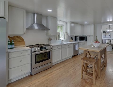 Kitchen with range/oven, fridge, microwave, and dishwasher