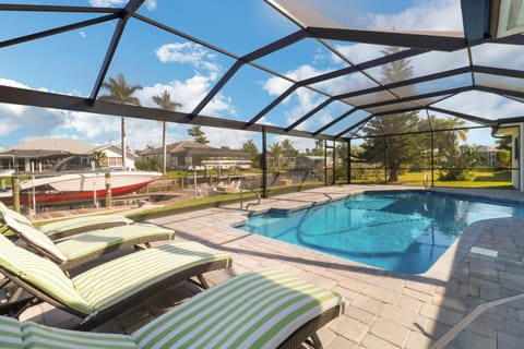 Live like a native in this lovely Cape Coral canal front pool home! Enjoy endless hours of family fun in your private outdoor living space!