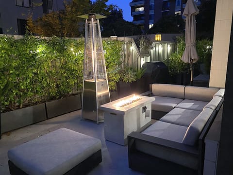 Wrap around garden with sectional seating, fire pit  and heat lamps.