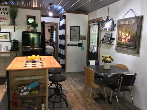 Adorable kitchen, barnwood on the bar area and stools to sit ,open shelves 