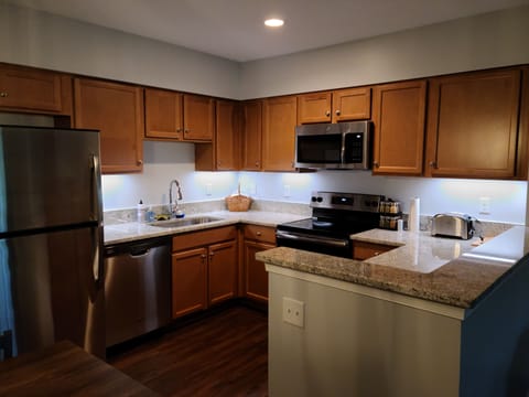 Modern kitchen with granite and stainless steel appliances.