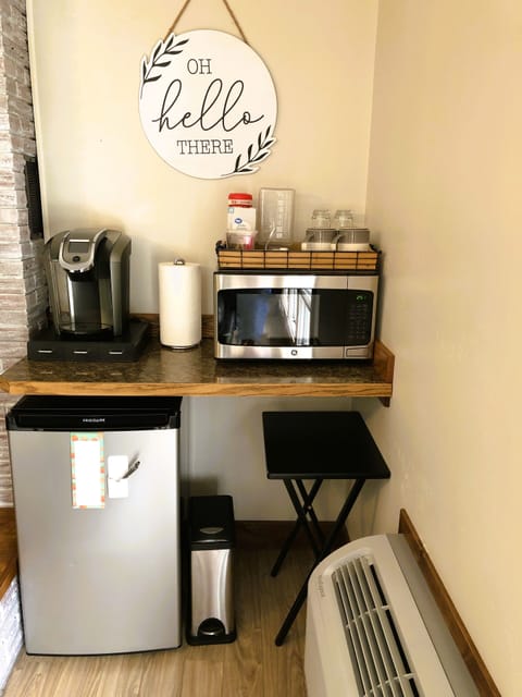 Coffee Bar, including coffee pods, creamer, sugar, microwave and minifridge.