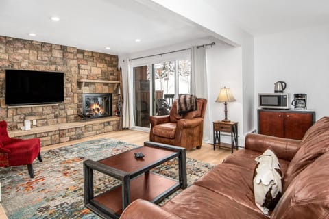 Spacious living room with open floor plan and fireplace