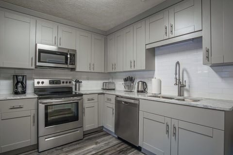 Sleek, modern style kitchen with all proper utensils needed to cook up a feast