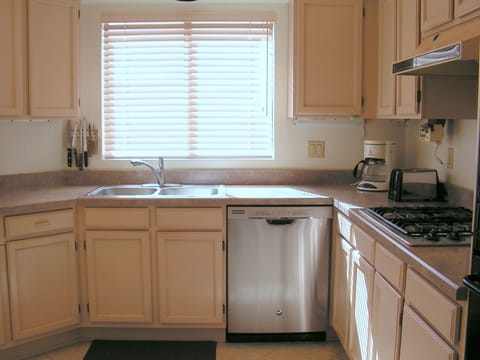 Gourmet gas cook-top; high-end stainless steel appliances, pull-out drawers.