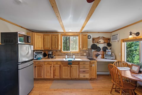 Main Cabin Kitchen with fridge, coffee pot, air fryer oven, cooktop, pots, pans