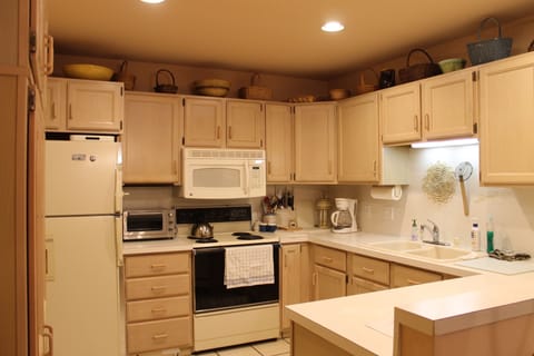 Kitchen complete with pots, pans, dishes, utensils, and appliances