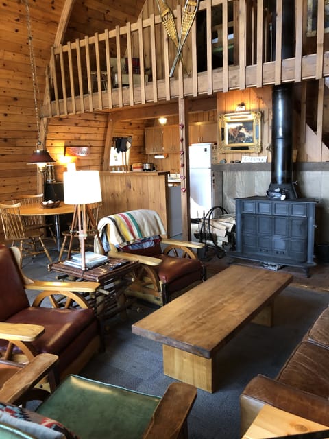 Main sitting area features a wood-burning stove and Spanish sunburst tiles