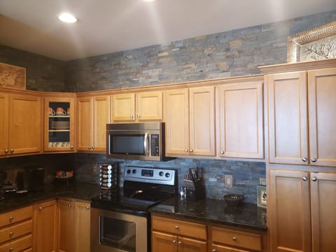 Recently remodeled kitchen with stone wall.
