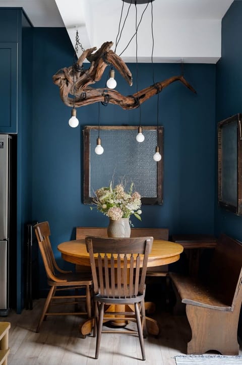 A salvaged driftwood piece turned light fixture hangs above the dining area.