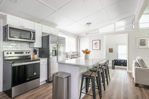 Open kitchen with quartz counters and stainless steel appliances