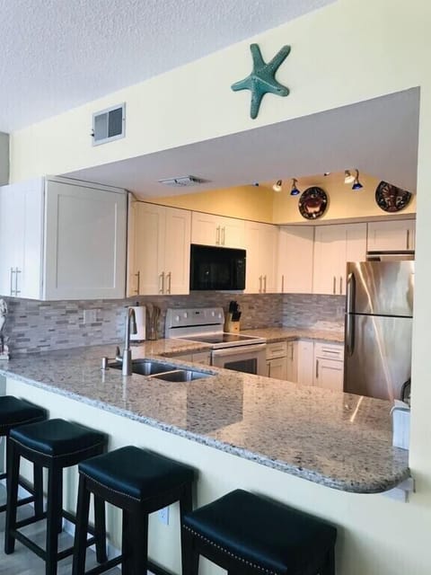 Updated Kitchen-new cabinets and granite countertops with bar seating for 4.