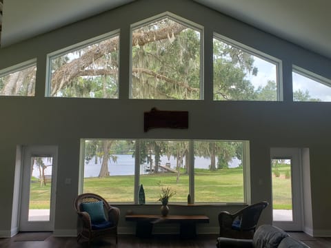 Numerous large windows span the back of the house with a beautiful lake view.