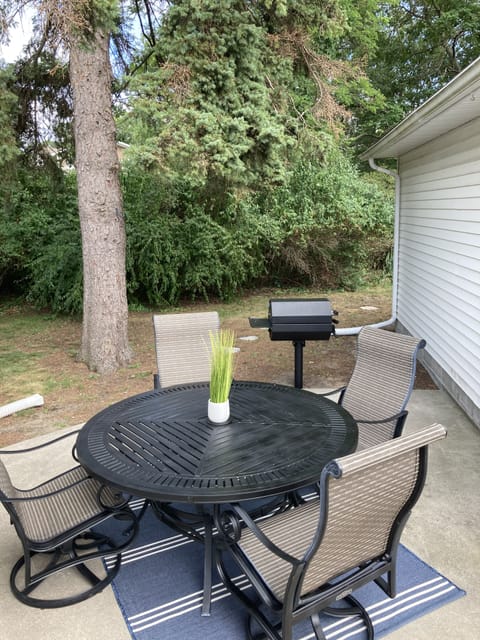 Relaxing outdoor area with charcoal grill. 